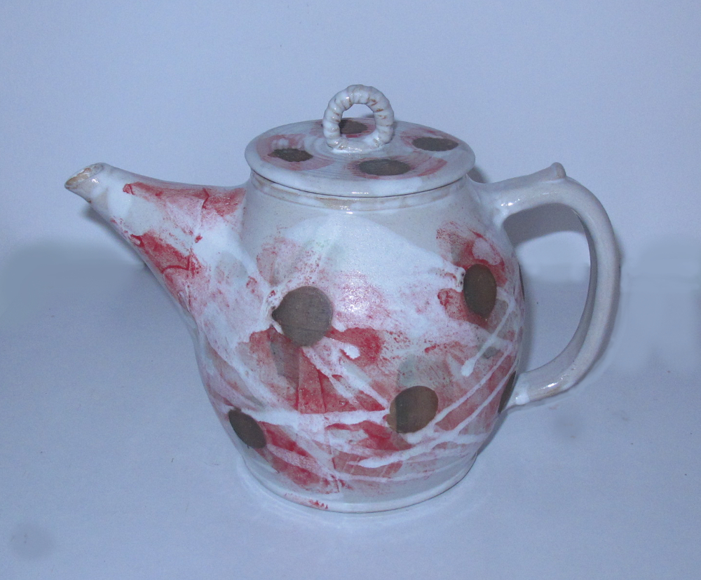 white and red tea pot